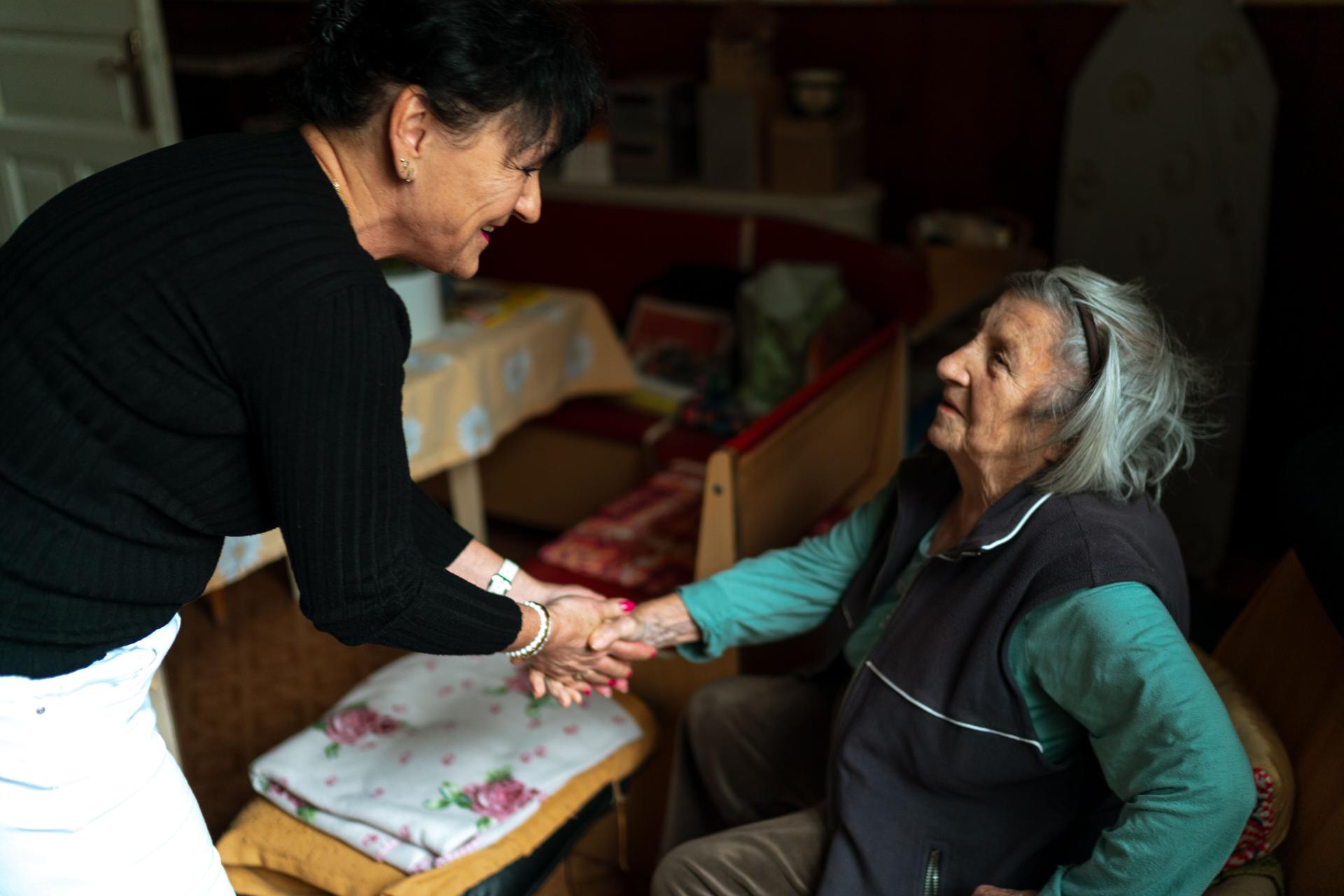 Smiling caregiver helping client